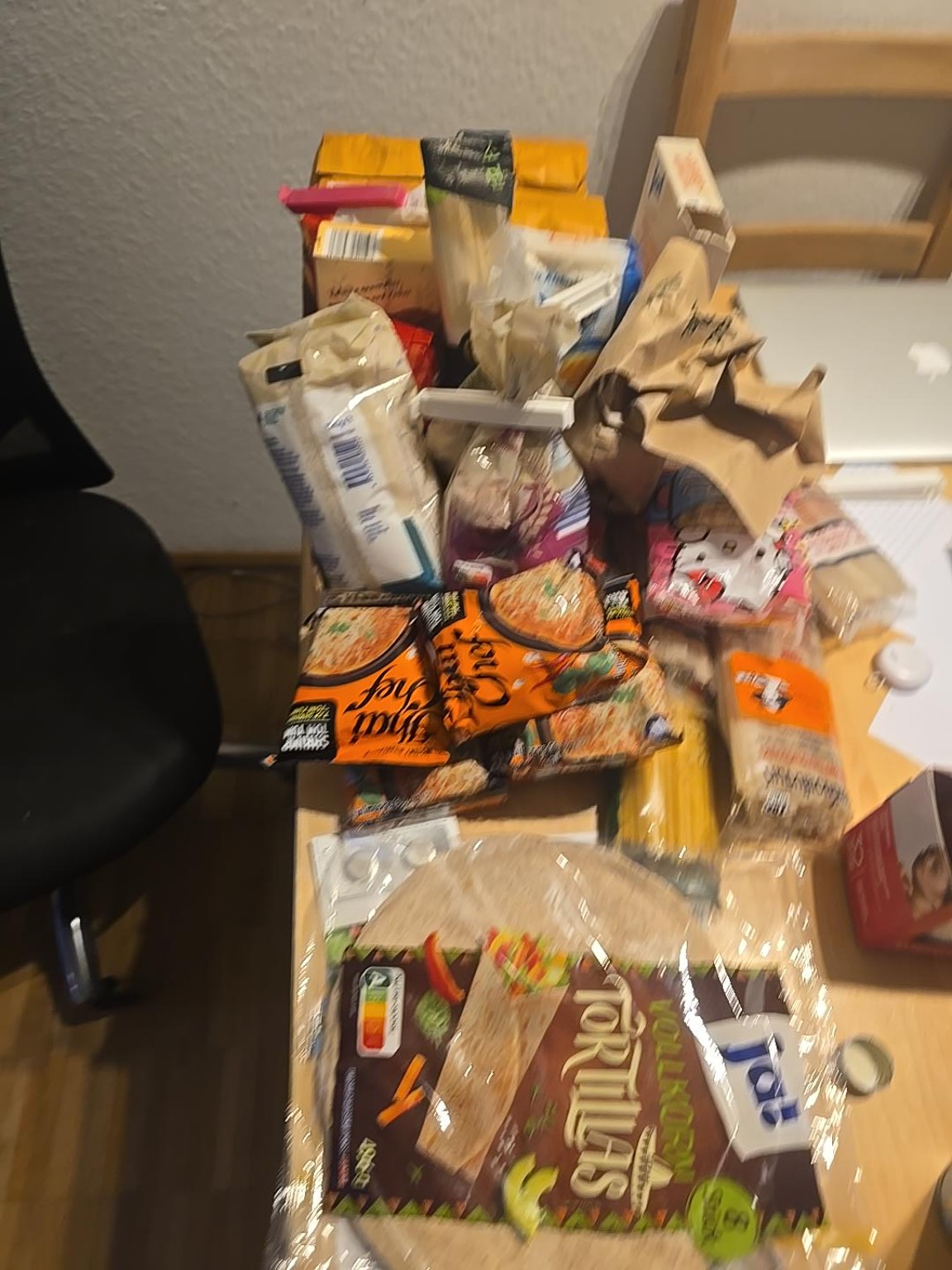 SUPPLY HOLDING AREA — Remaining dry-food provisions awaiting defensive storage containers.